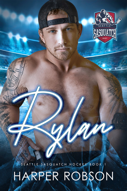 Paperback Book Cover of 'Rylan: Seattle Sasquatch Book 1' featuring a male hockey player with tattoos,  wearing a backwards baseball cap. The title and author's name are prominently displayed.